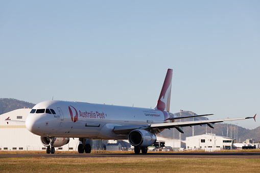 Townsville, Australia - 10 August 2022: Qantas Airbus A321 air freight aircraft preparing for take off at Townsville Airport, Queensland (TSV) in the early morning.