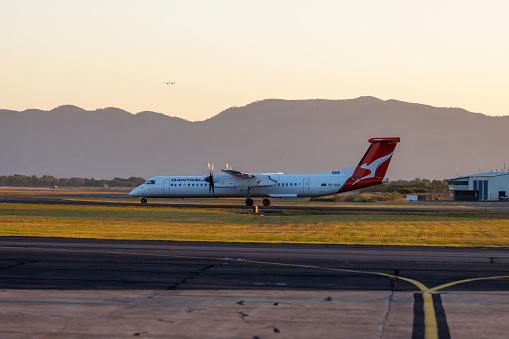 Townsville, Queensland - 10 August 2022: QantasLink Bombardier DHC-8 taxiing on the runway at Townsville airport in north Queensland.