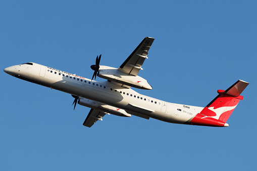 Townsville, Queensland - 10 August 2022: QantasLink Bombardier DHC-8 taking off at Townsville airport in north Queensland.
