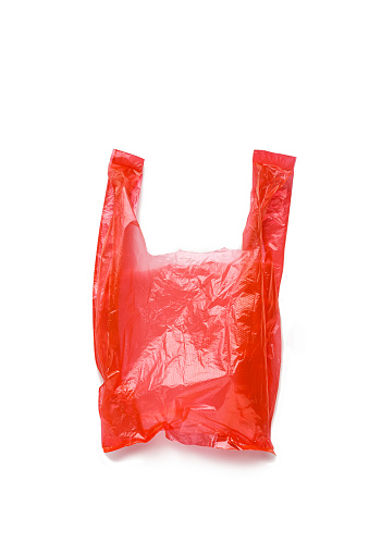 Top view wrinkled Red plastic bag isolated on white background, cut out object. Close up Single-use polythene packet, empty Cellophane bag for grocery, waste reduction, reusable materials, non-plastic