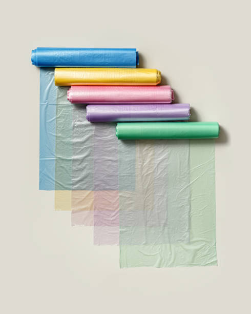 istock Set colored plastic bags in rolls as flat lay pattern. Bright colorful polyethylene packets for food, beige background. Many new clear disposable polythene bags. Not eco friendly consumption 1719861278