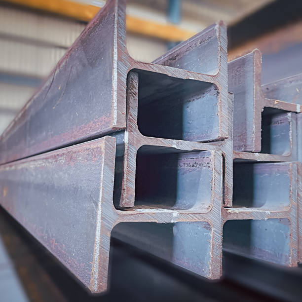 istock Steel beams production. Metal girders stack on project construction , steel h-beam, selective focus, Raw materials used in building construction. 1719870119