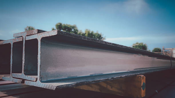 istock Steel beams production. Metal girders stack on project construction , steel h-beam, selective focus, Raw materials used in building construction. 1719870653