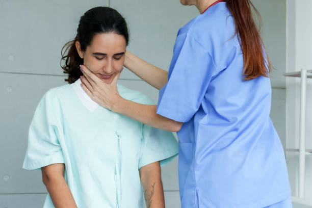 istock Anonymous physical therapist holds patient's neck Realigns bones to restore muscle strength To be able to use normally According to the advice of the orthopedic doctor in the hospital examination room 1719873413