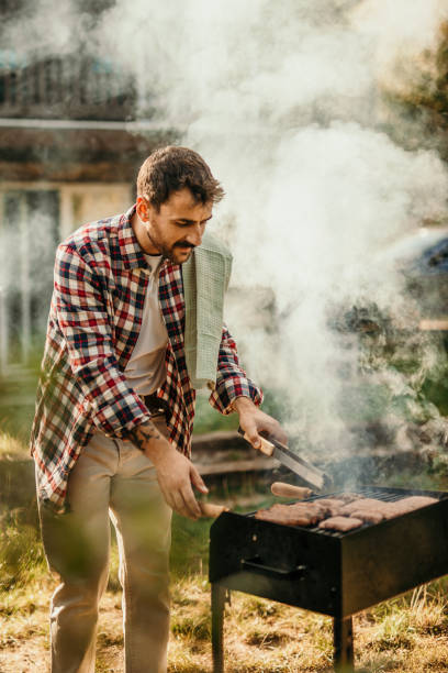 istock Proud male chef making a BBQ in his backyard on a sunny autumn day. 1719913091