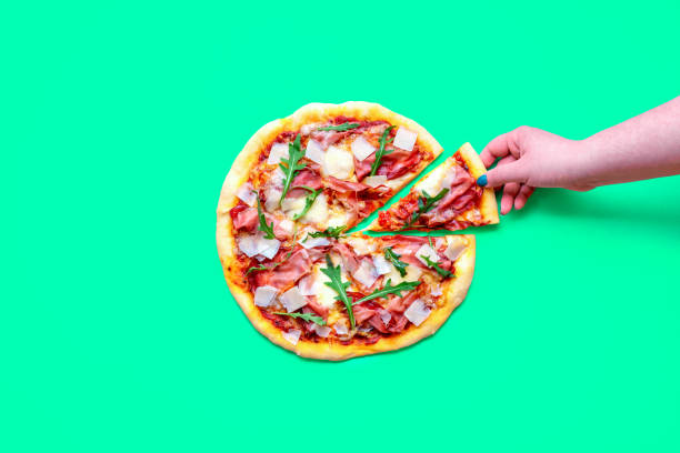 istock Prosciutto pizza above view, minimalist on a green background 1719927622