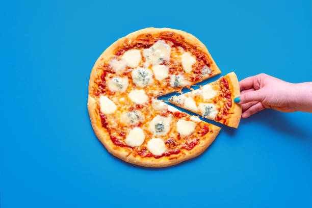 istock Pizza quattro formaggi, top view on a blue table 1719927628
