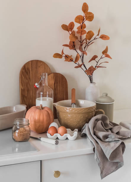 istock Cozy autumn kitchen interior - cooking pumpkin pastries. Ingredients and dishes on the kitchen table 1719932363