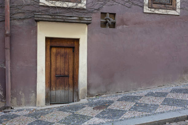 ancient street with old lavender wall and old door outside