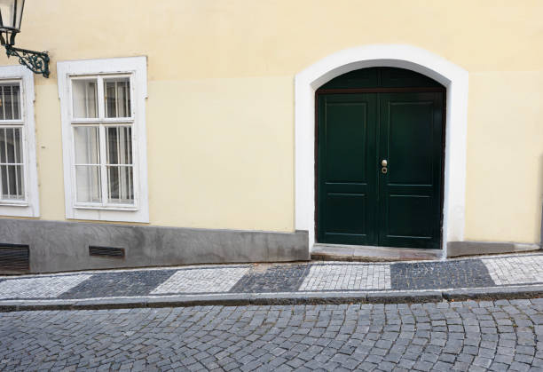 selective focus on old street with cobblestones and front door with windows