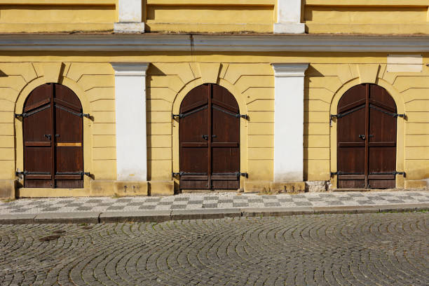 istock selective focus on three huge semi-circular wooden doors. 1719935566