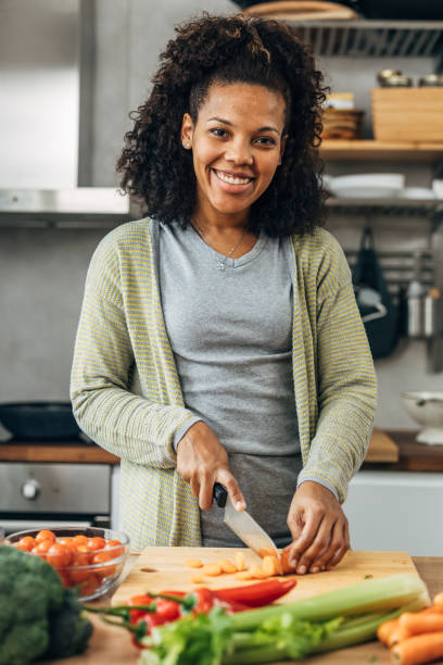 istock Multiracial woman prepares food in kitchen 1719936715
