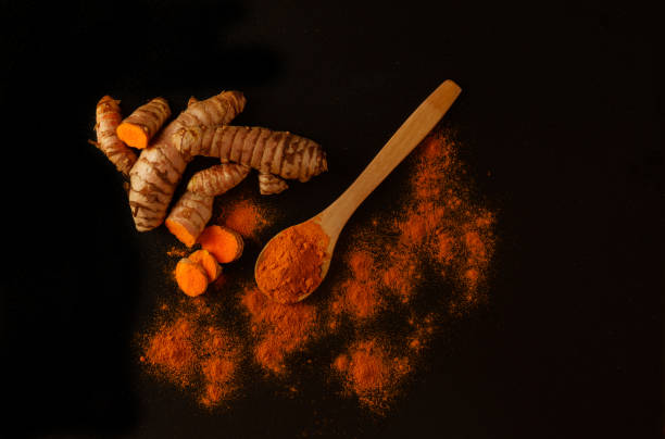 istock fresh turmeric root and ground turmeric on a wooden spoon 1719946030