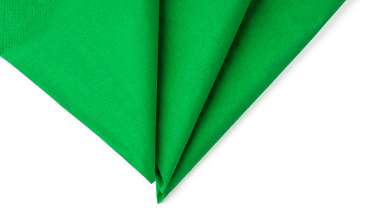 Green paper napkins on white background close up photo