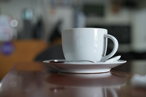 Coffee drink in a white glass placed on a cafe table