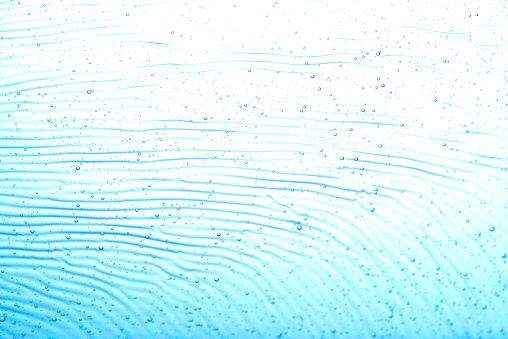Close-up of blue wave pattern with bubbles.