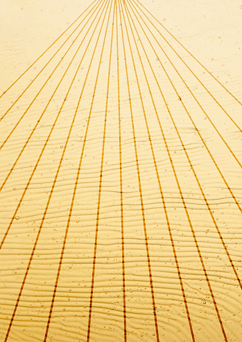 Close-up of yellow wave pattern with vanishing point line.