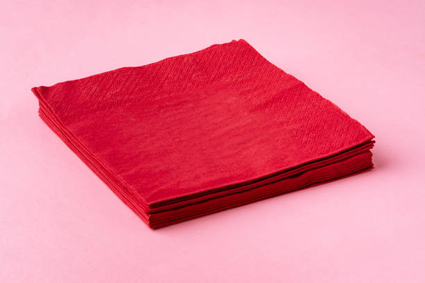 istock Paper napkins on pink background close up 1720037500