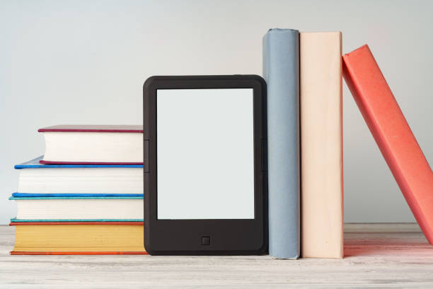 istock Digital tablet with a stack of books on gray background 1720037502