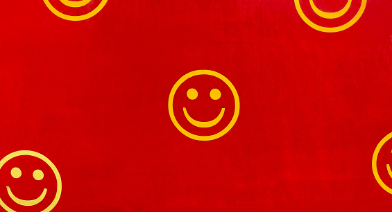 Smiley faces on the red wall.