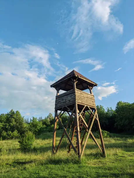 hunters watchout tower. wooden defenders watchtower in forest meadow
