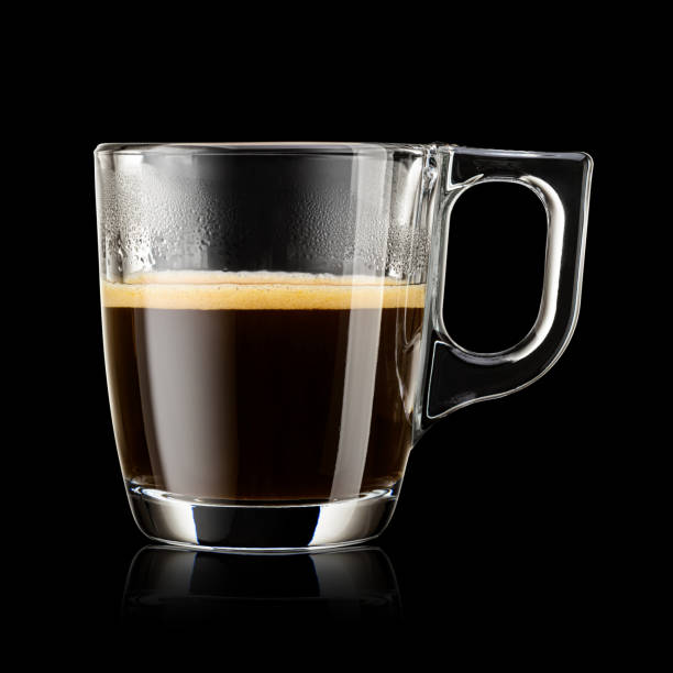 istock Transparent glass mug with espresso coffee on black background. 1720088449