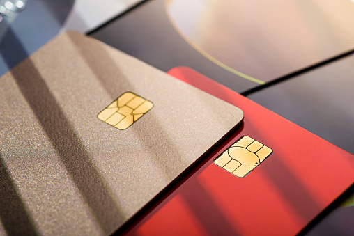 Stack of different credit cards, close up view with selective focus. Plastic card payment.