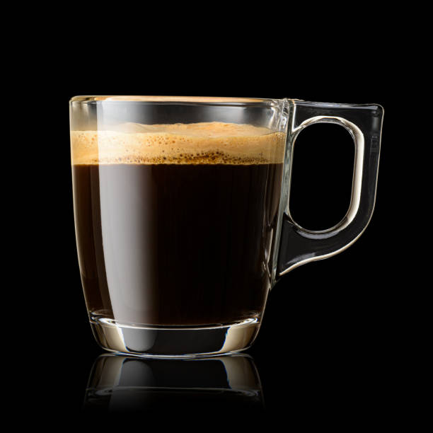 istock Transparent glass mug with espresso coffee on black background. 1720088481