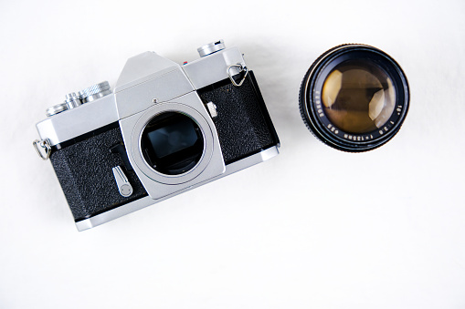 Top view of vintage cameras on white background desk for mockup