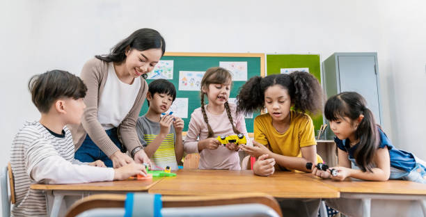 istock Group of student teacher workshop robotic car toy in classroom. Learning by playing education group study concept. International pupils do activities brain training in primary school background banner 1720115914