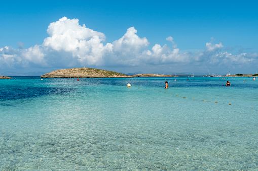 Illetes beach in Formentera island Ibiza Balearic islands Spain on September 14, 2023 swimmers in the turquoise water