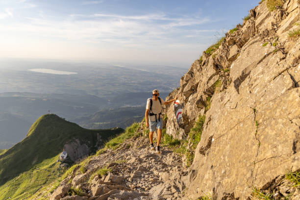 istock Man hikes along rocky mountain ridge at sunrise 1720140803