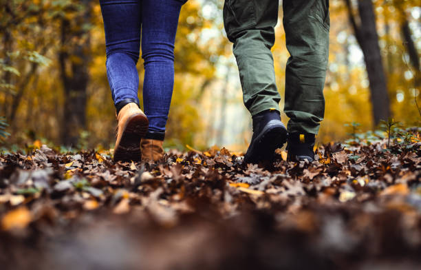 istock Close up of two hikers feet walking in forest. 1720161964