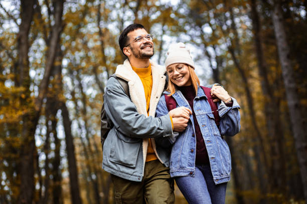 istock Portrait of couple spending time together walking in forest. 1720162005