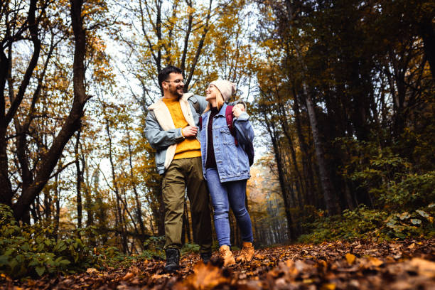 istock Portrait of couple spending time together walking in forest. 1720162009
