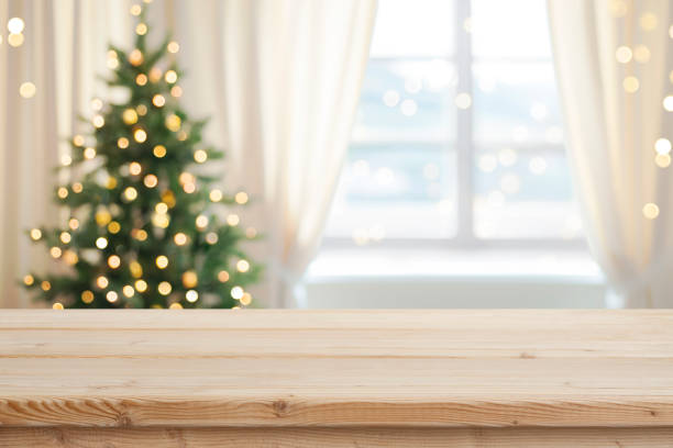 istock Desk space in front of window with Christmas tree background 1720193734
