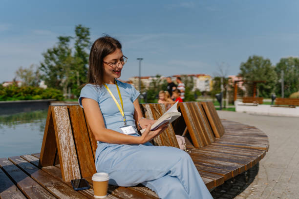 istock Young female nurse reading a book, while enjoying the nice weather 1720205281