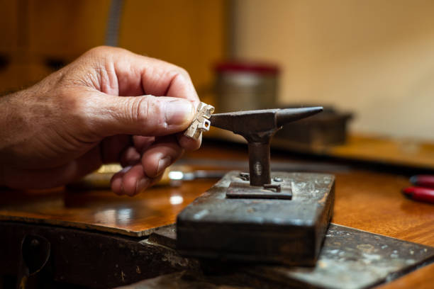istock Goldsmith working with an anvil in his crafting jewelry workshop 1720244853