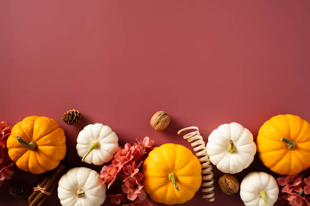 Autumn background with pumpkins and fall decorations on brown background. Flat lay, top view. Thanksgiving concept.