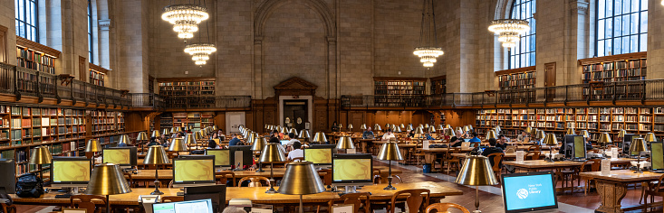 New York Public Library, USA - September 18, 2023.  A panoramic interior of students reading and researching subjects in the historic Rose Main Reading Room at The New York Public Library in Midtown Manhattan