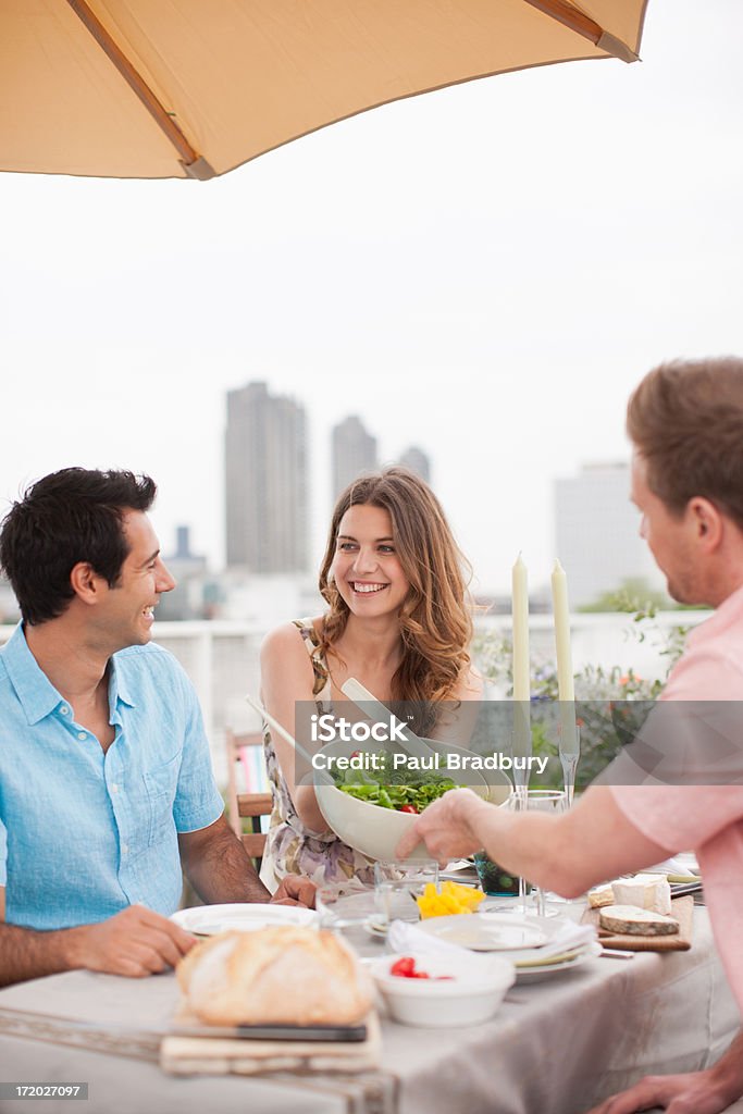 Couples enjoying party on balcony  25-29 Years Stock Photo