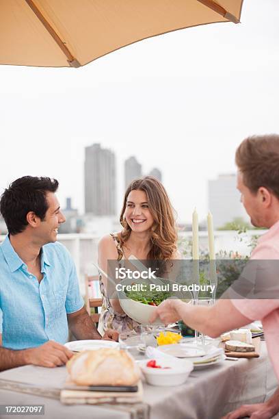 Couples Enjoying Party On Balcony Stock Photo - Download Image Now - 25-29 Years, Adult, Adults Only