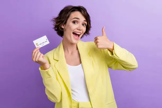 Photo of young shopaholic businesswoman spend holidays spend her money mastercard like feedback isolated on purple color background.