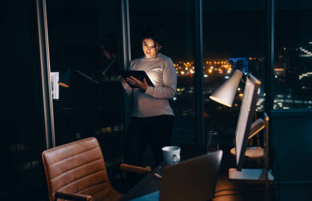 istock Female entrepreneur using a tablet in her office at night 1720307289