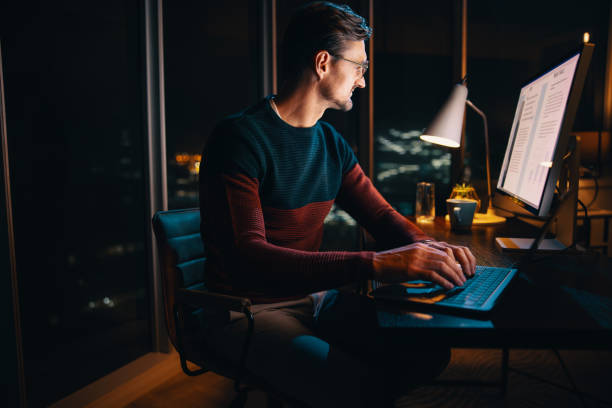 istock After hours: Late night work in a busy office with a young entrepreneur typing on laptop 1720307814