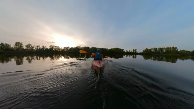 Kayak paddling at the sunset