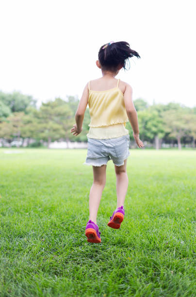 Little Girl Running on the Grass