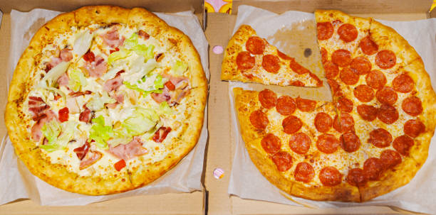 istock Pepperoni pizza and carbonara pizza cut into pieces. 1720329281