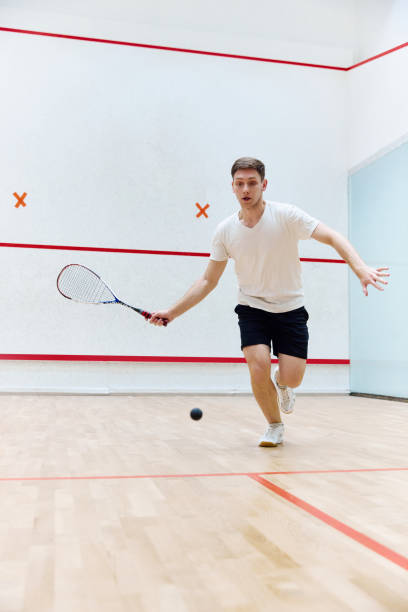 istock Young concentrated, athletic man playing squash, training on squash court, hitting ball with racket. 1720335387