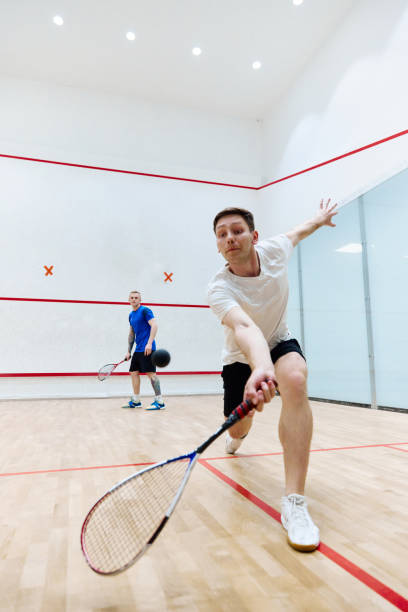 istock Young concentrated, athletic man playing squash, training on squash court, hitting ball with racket. 1720335397